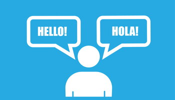 a figure of a cartoon person with two word bubbles, one saying hello and the other saying hola
