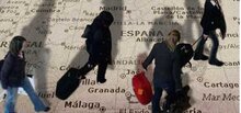 Figures walking on map of Spain